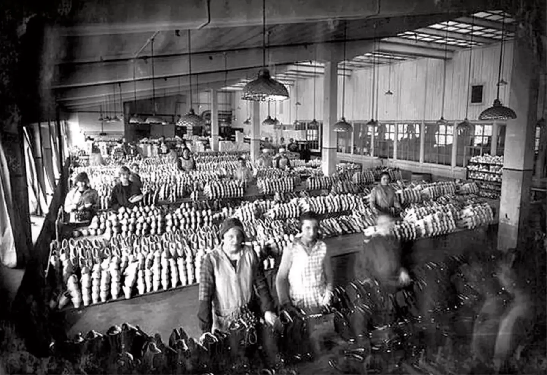 Galosch- och stöveltillverkning i fabriksalen under tidigt 1900-tal